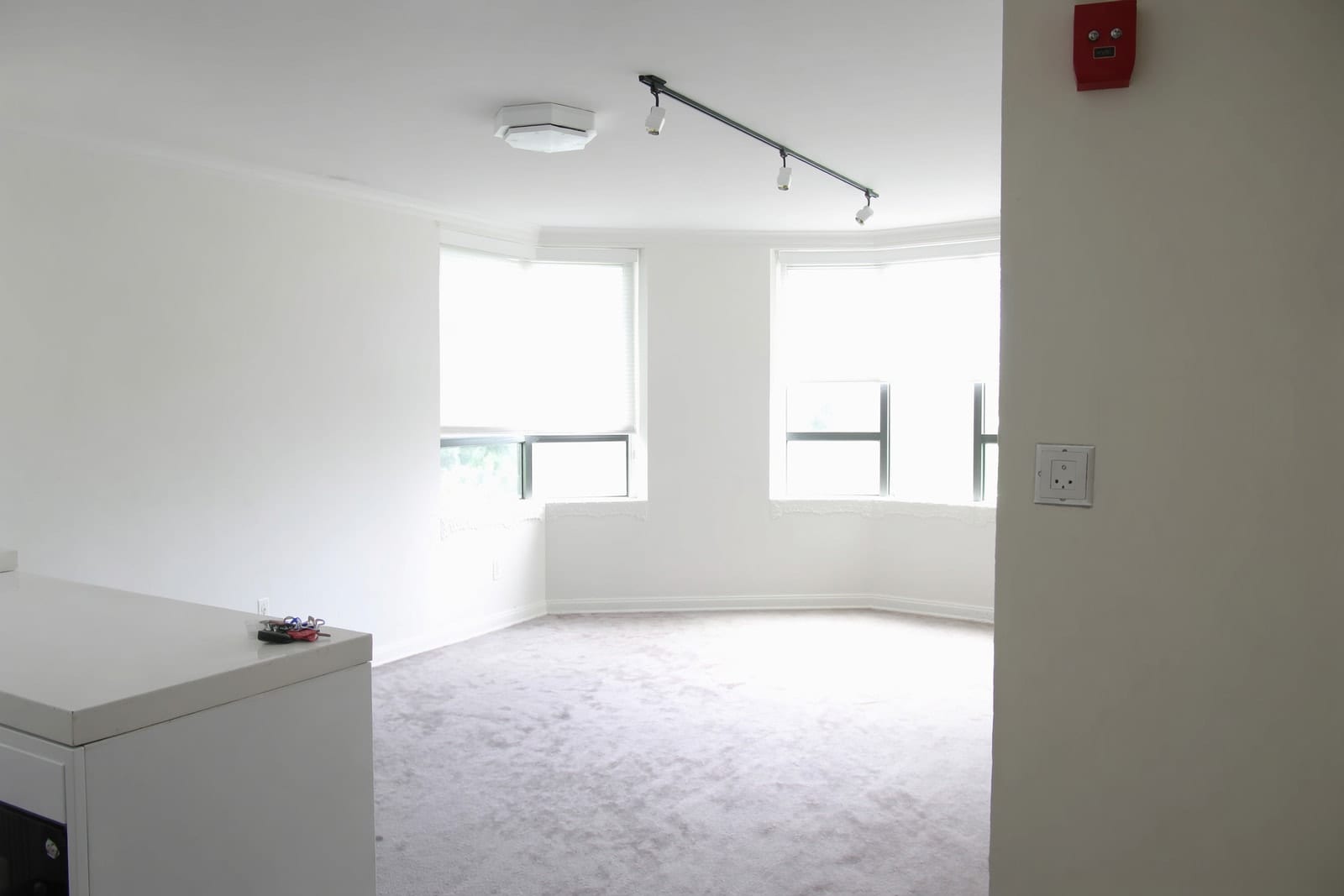 A bright, empty room with clean floors, ready for its next occupants.