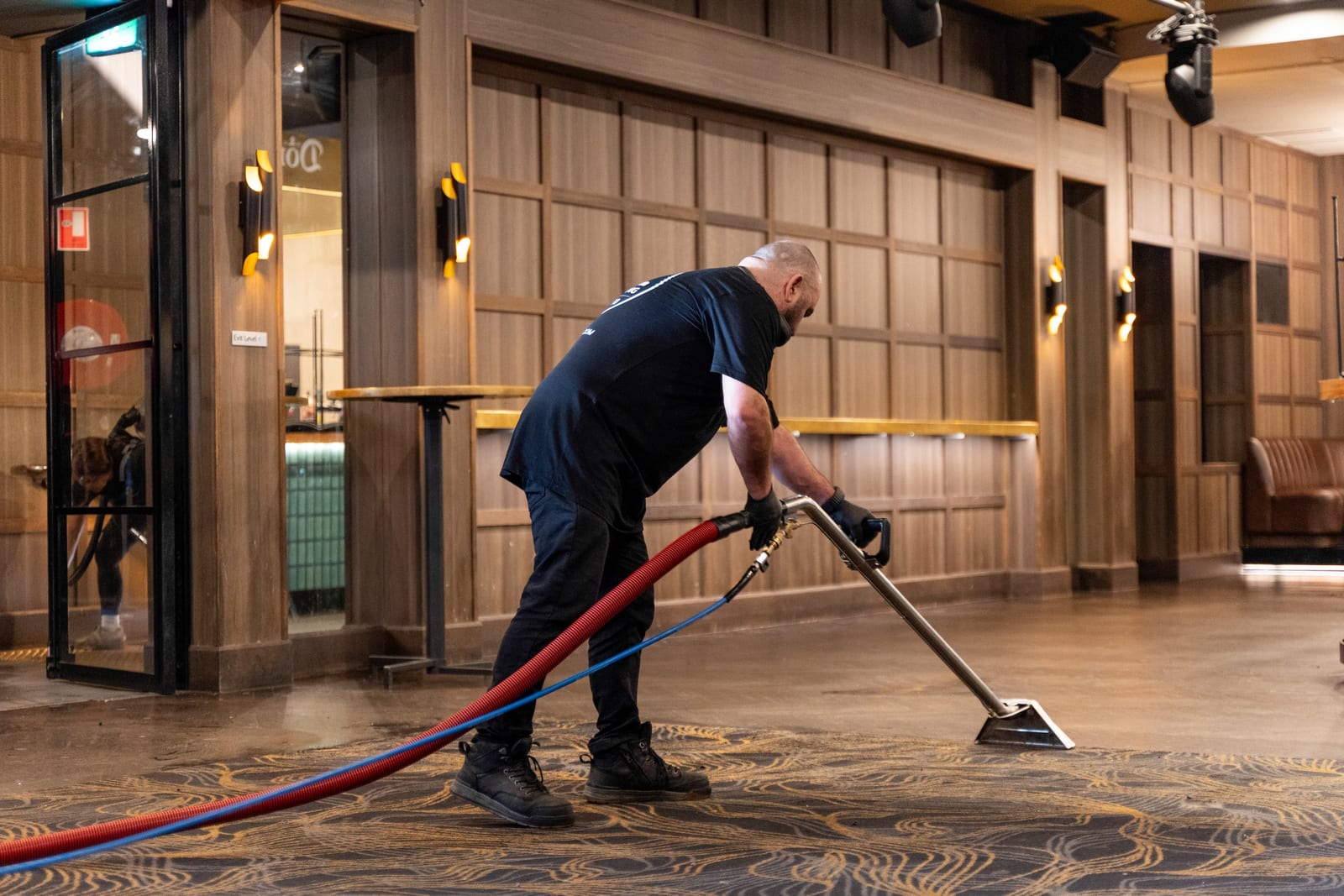 A HOZ CLEANING cleaner hot-water extracting a patterned carpet in a venue function room.